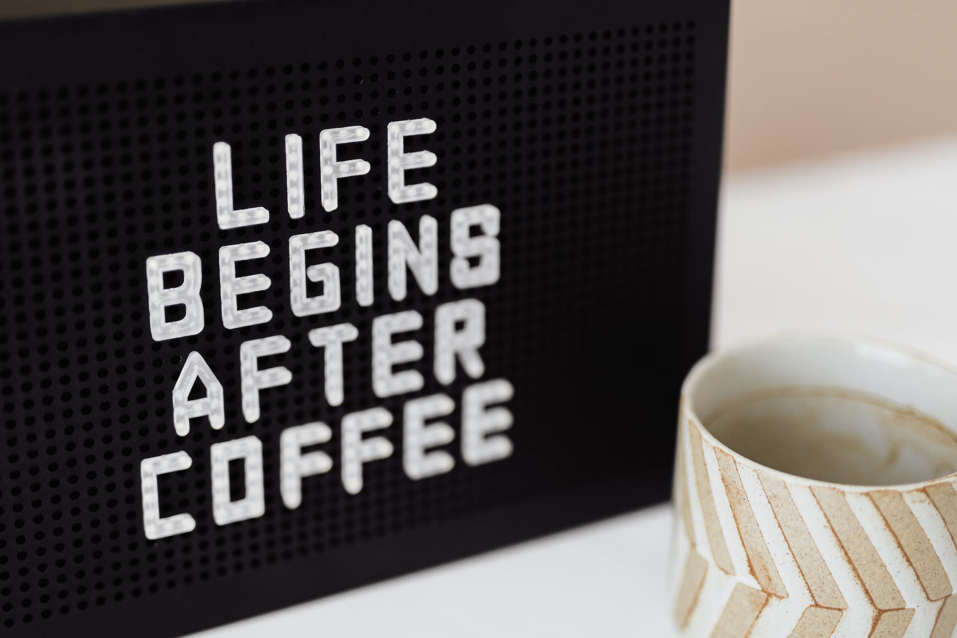 peg message board and cup of coffee
